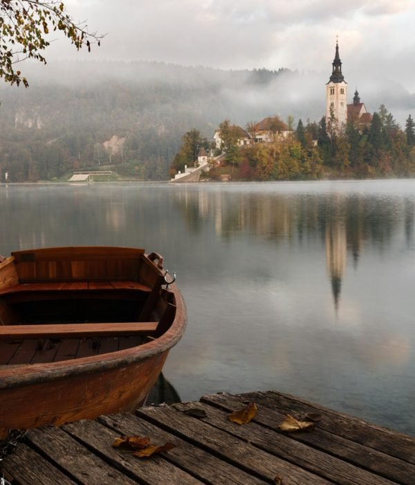 brown wooden boat floating on body of water